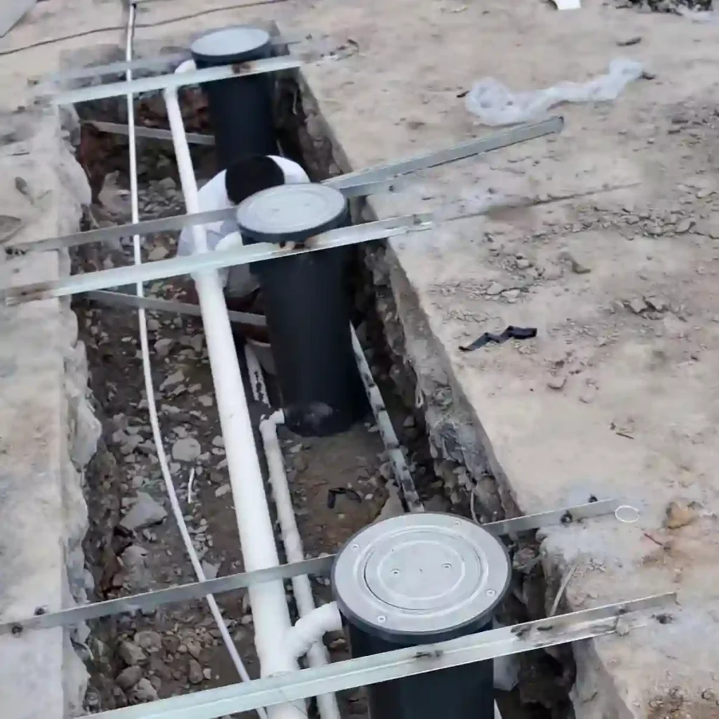 Connecting electrical conduits and drainage pipes between automatic bollards